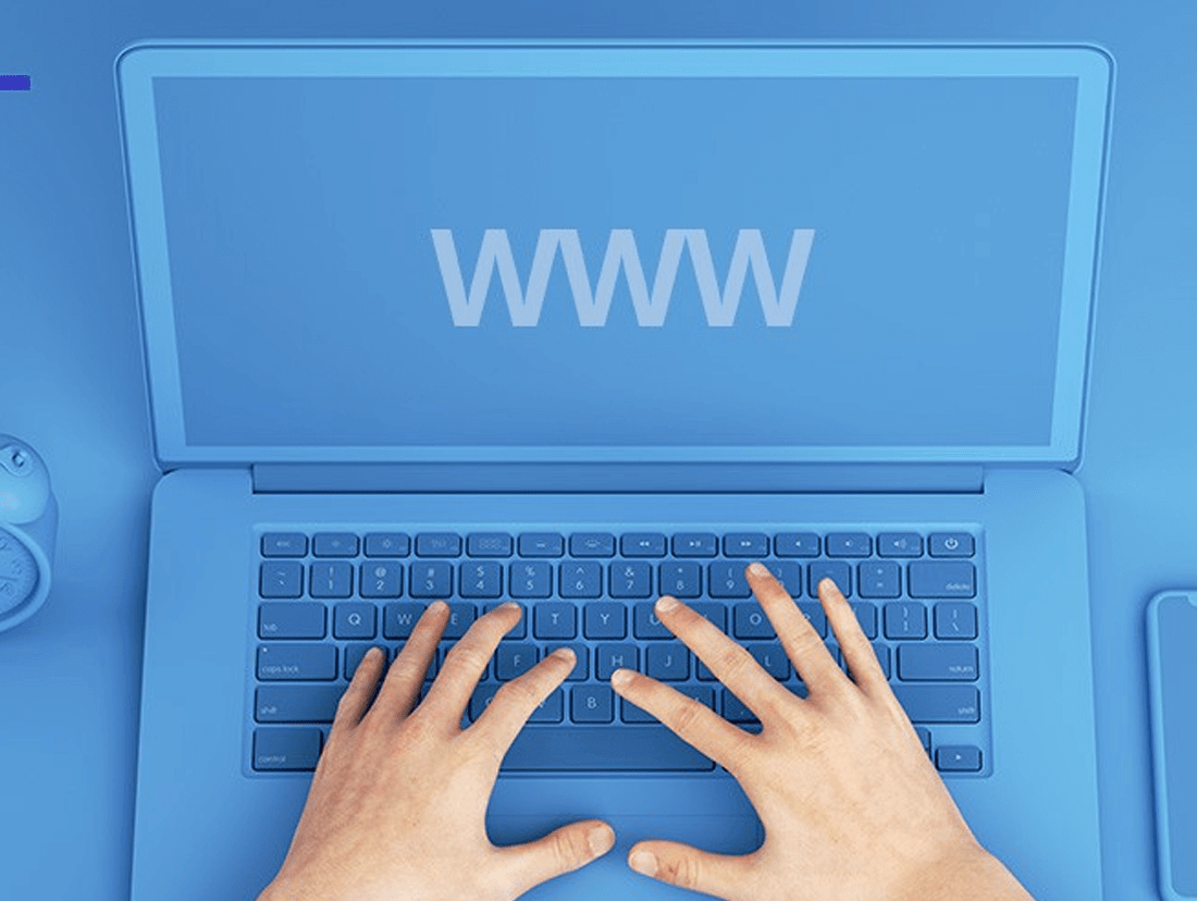 A person's hands are typing on a laptop with the word www on it.